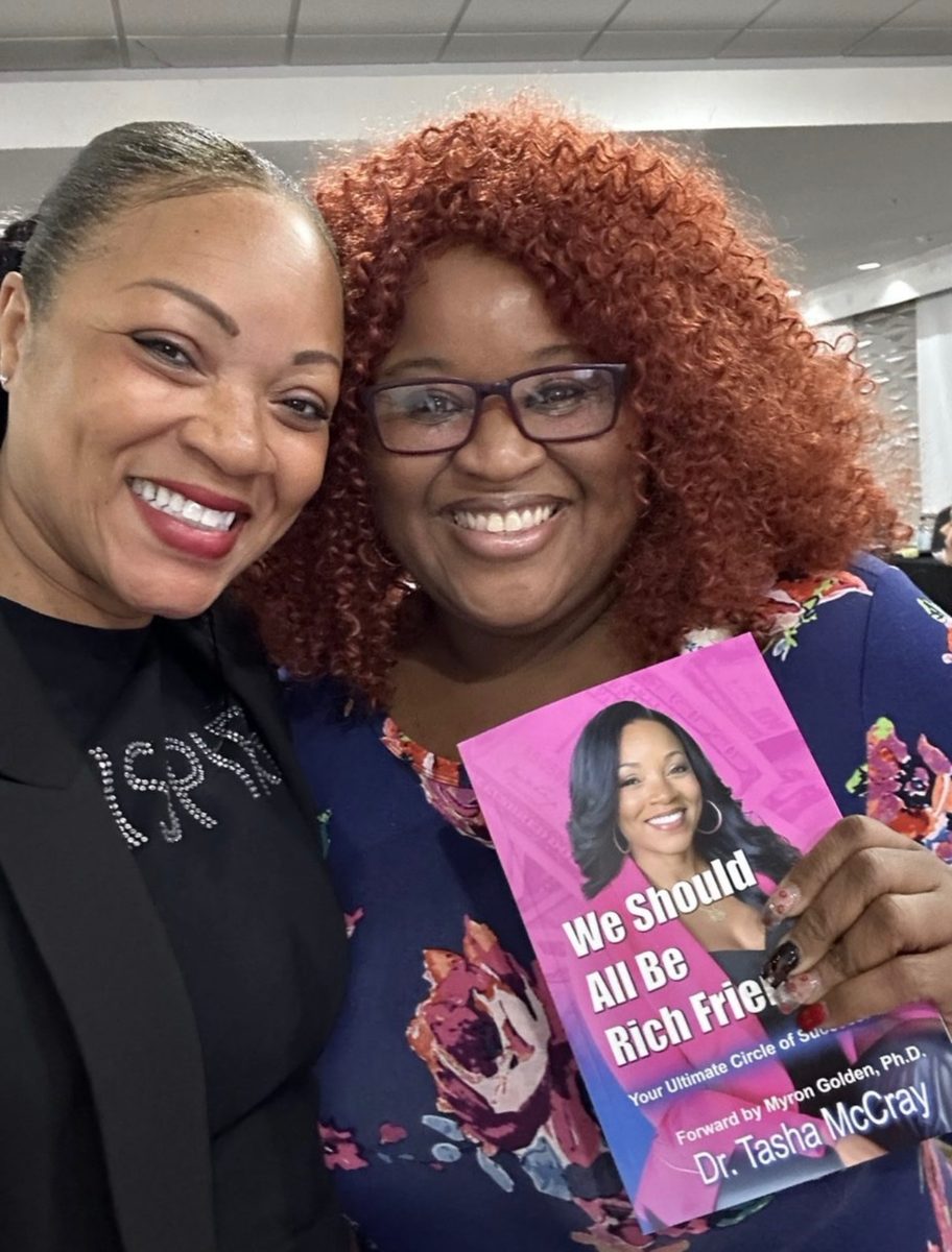 Two readers holding the book together